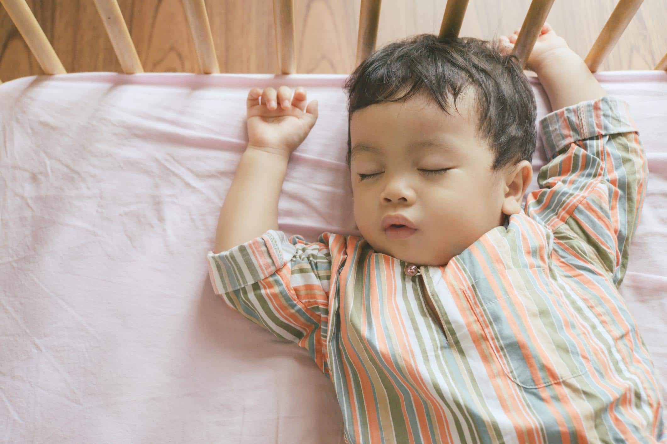 10-month-old baby sleeping in a crib