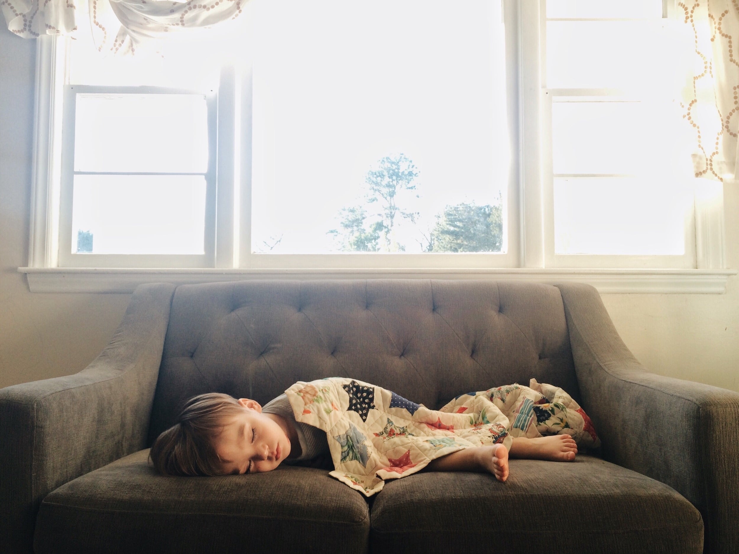little boy sleeping on the couch