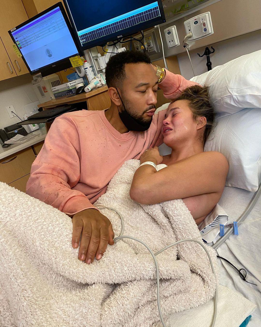 Chrissy Teigen crying next to John Legend