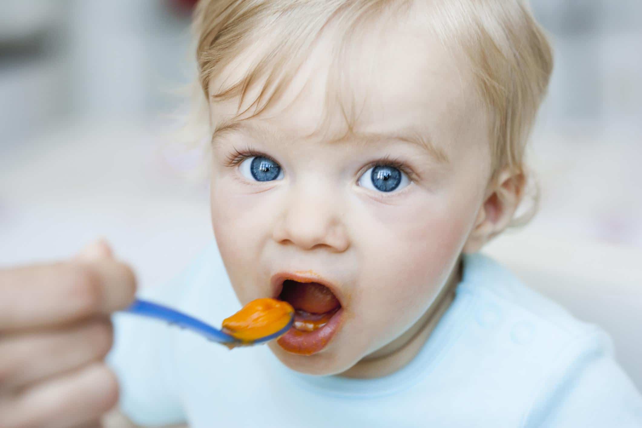 baby eating a spoonful of purees