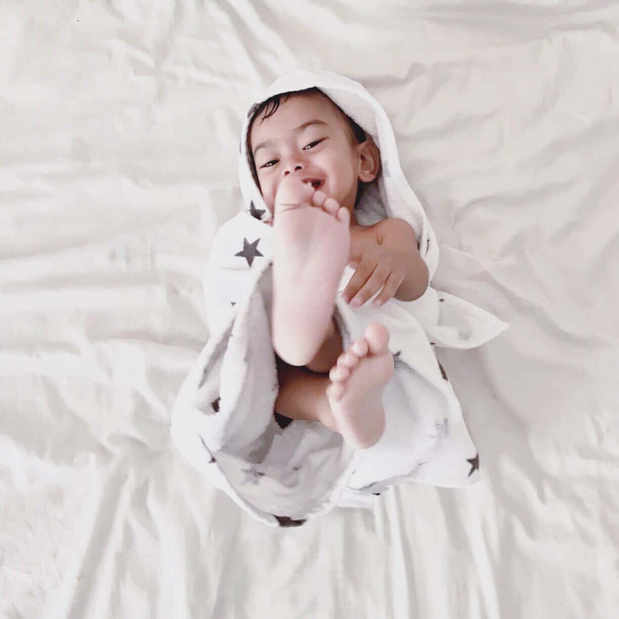 baby playing with a toy in a crib