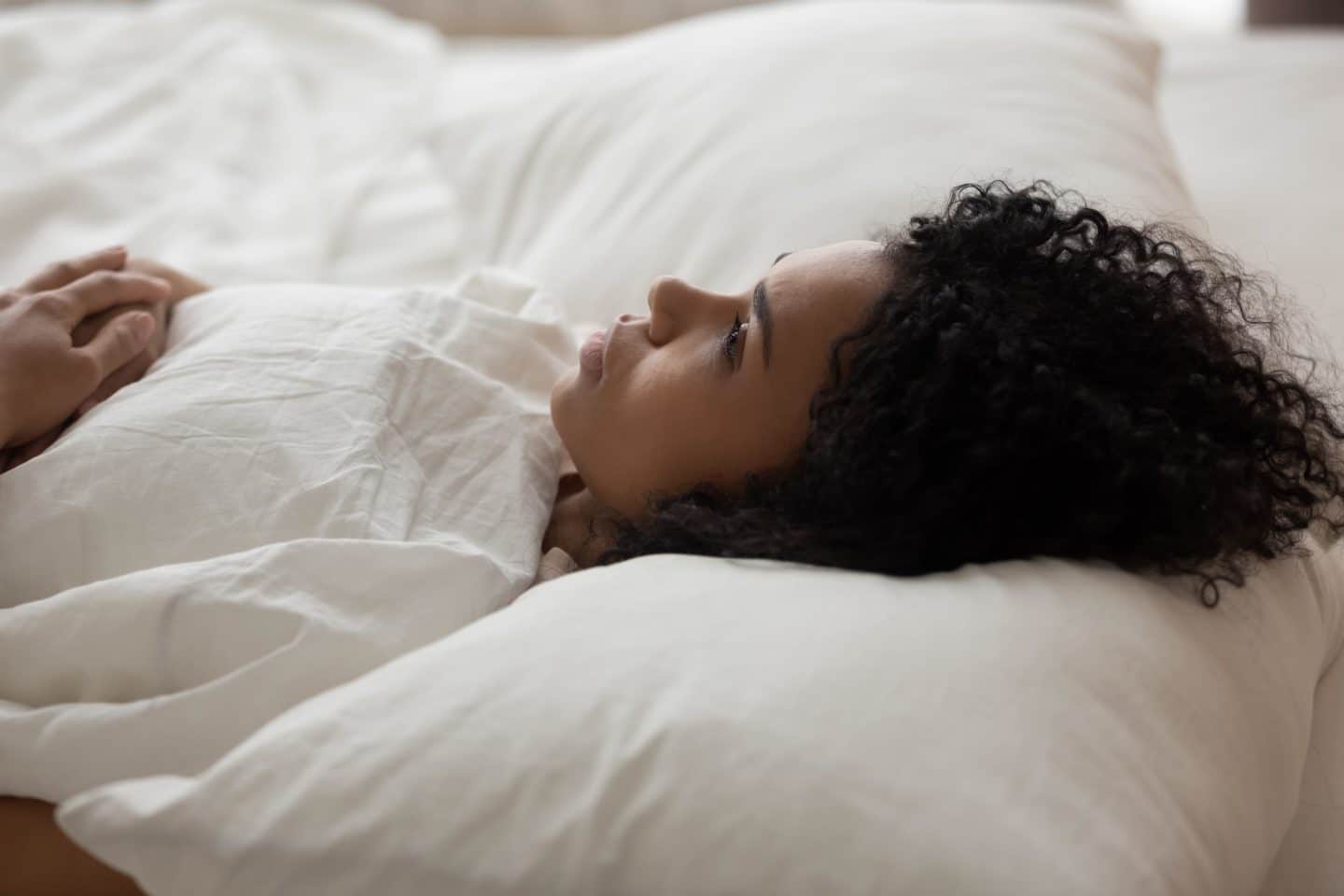 woman-lying-on-bed-staring-at-the-ceiling