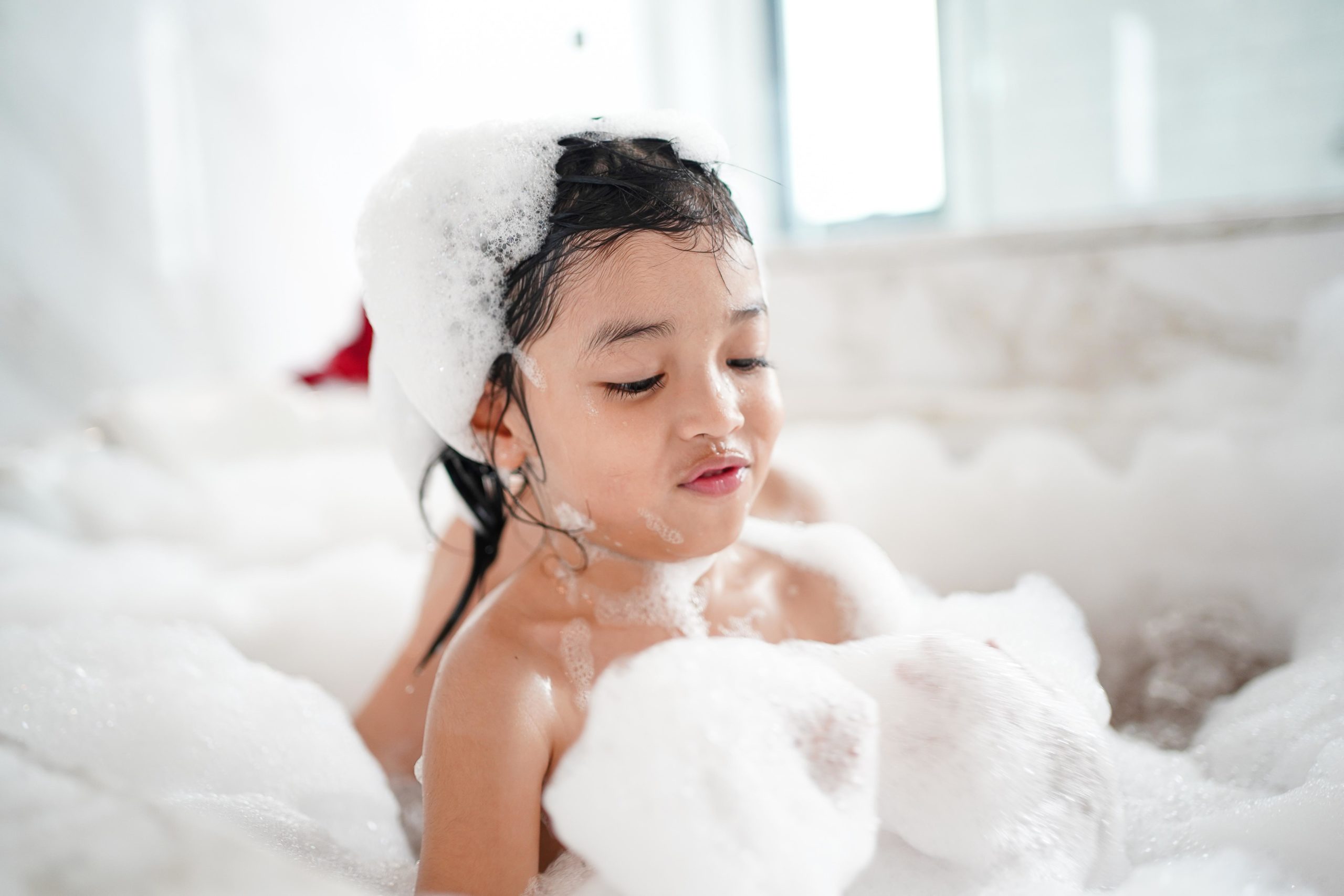 child playing in a bubble bath