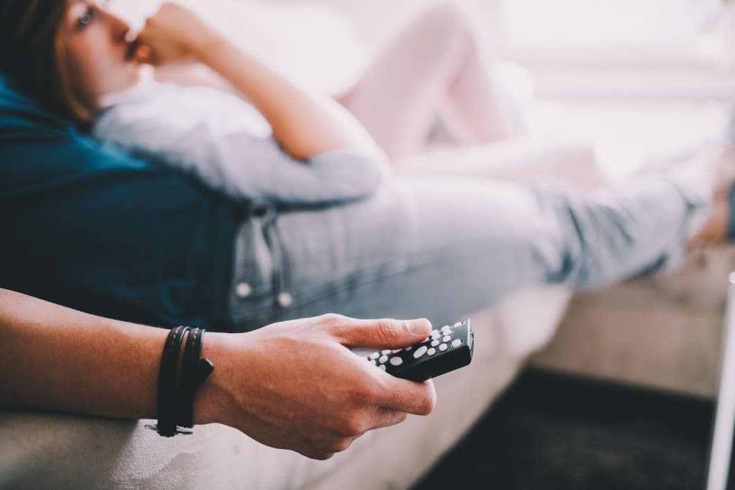 couple watching tv on the couch