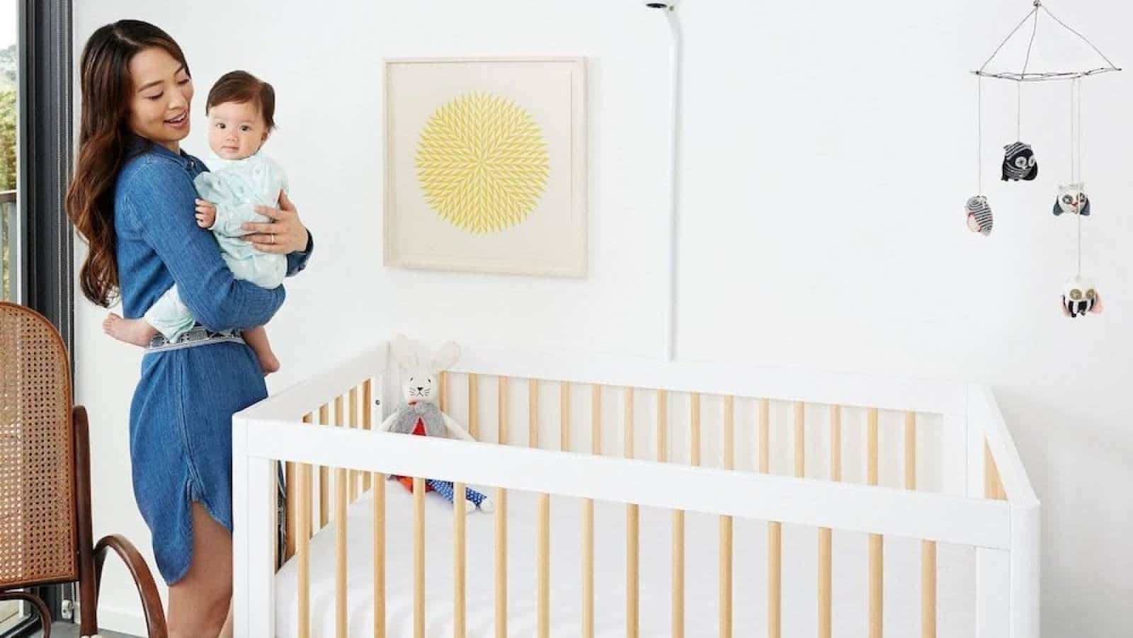 mom putting baby in a crib