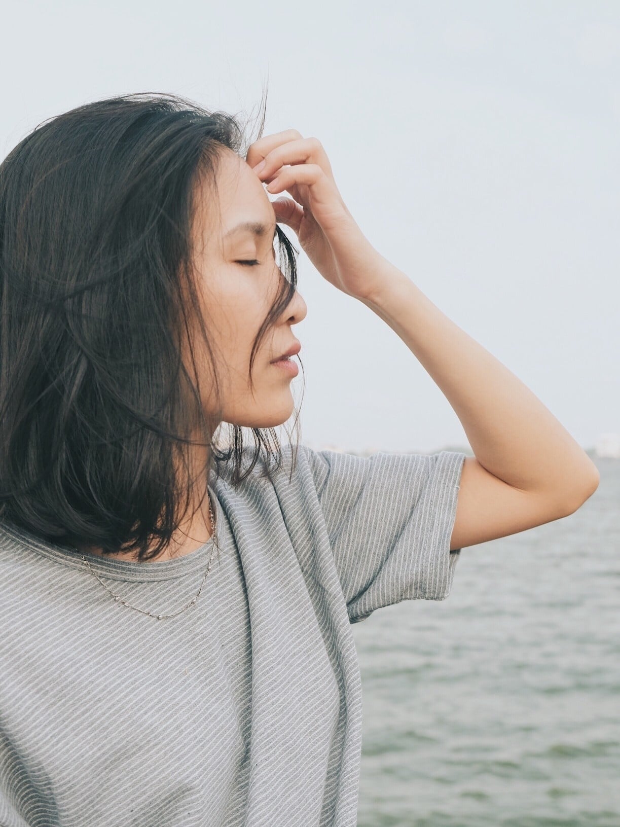 woman getting hair out of her face