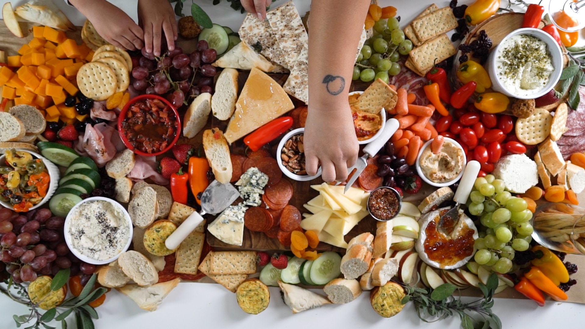 woman picking off a charcuterie board