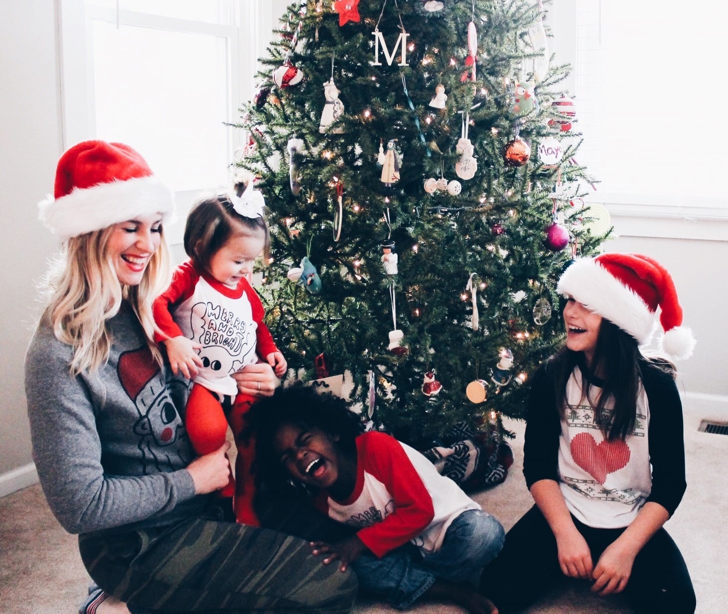 mom and kids giggling in front of christmas tree- practice gratitude