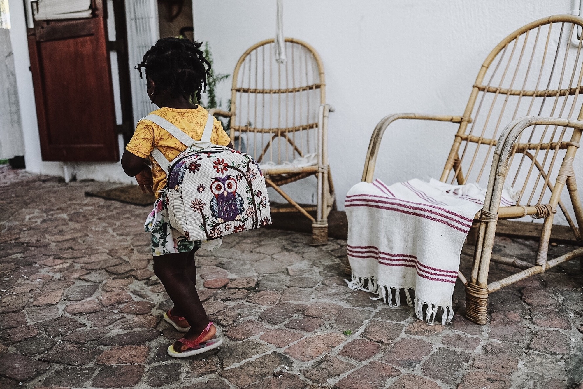 little girl walking with a backpack