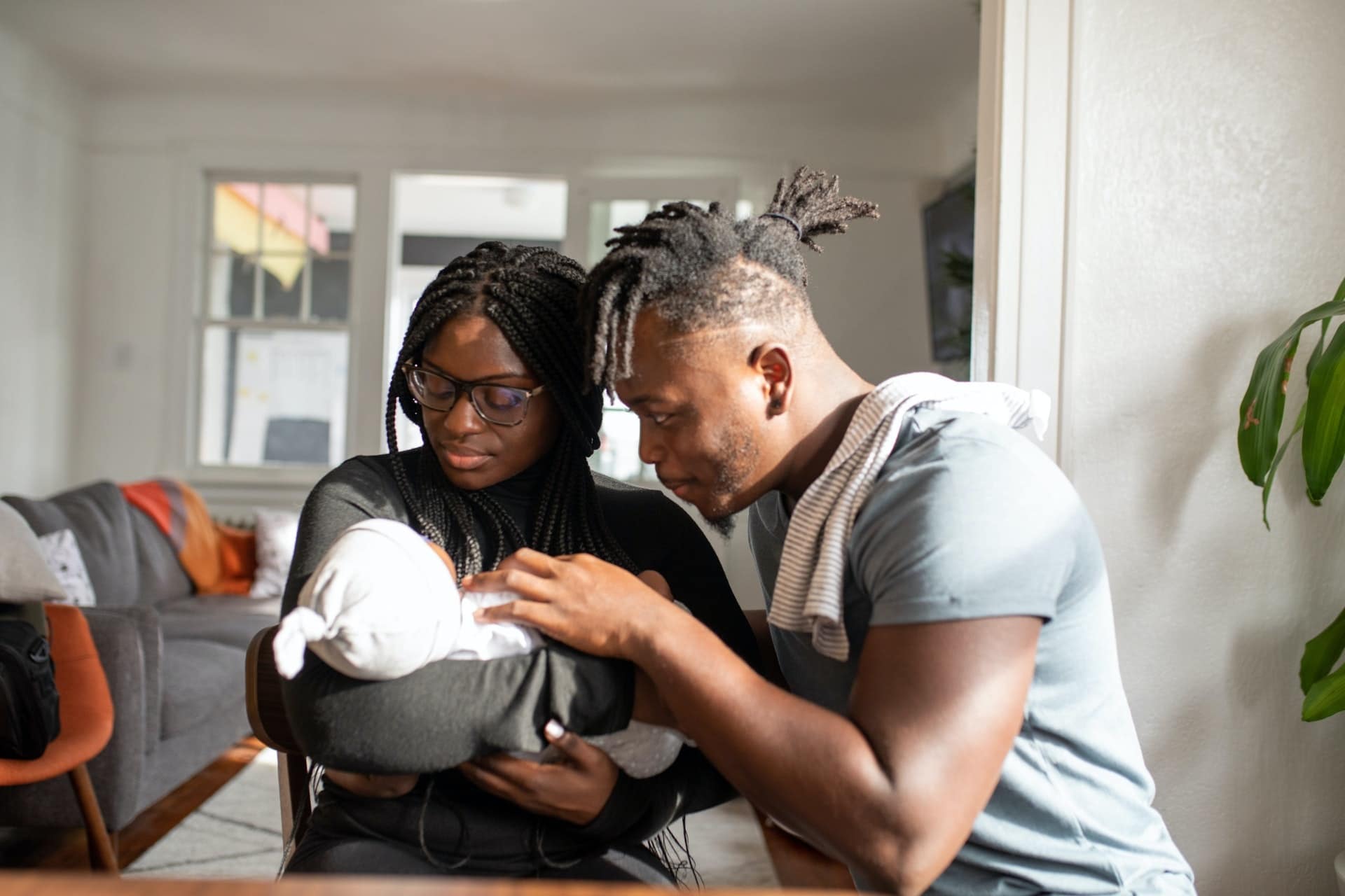 parents looking at a newborn baby