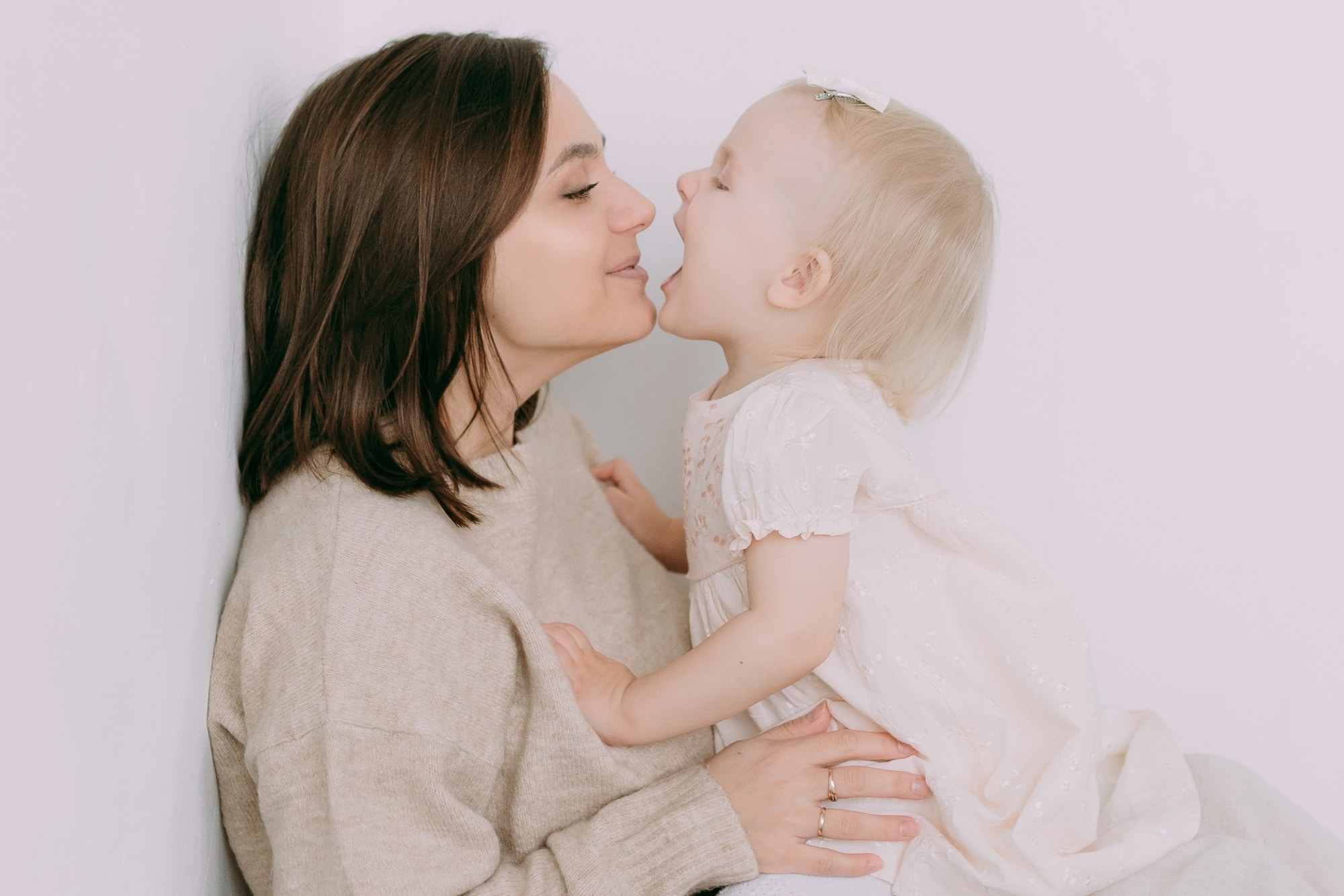 mom kissing toddler