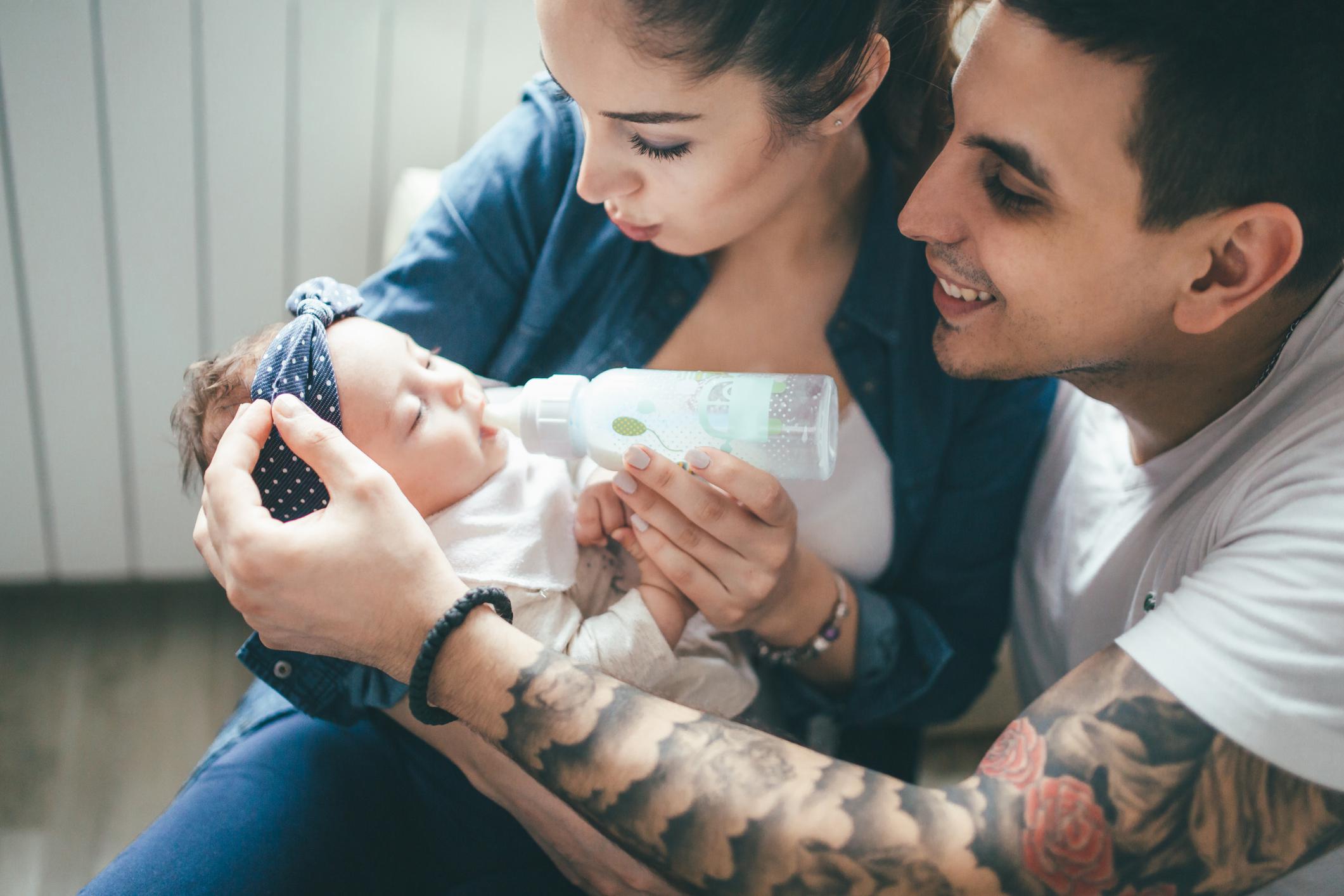 parents cuddling a baby - 11-week-old baby feeding schedule