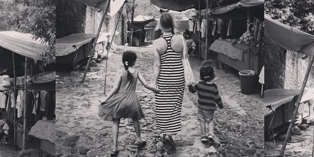 mom walking with daughters hand in hand