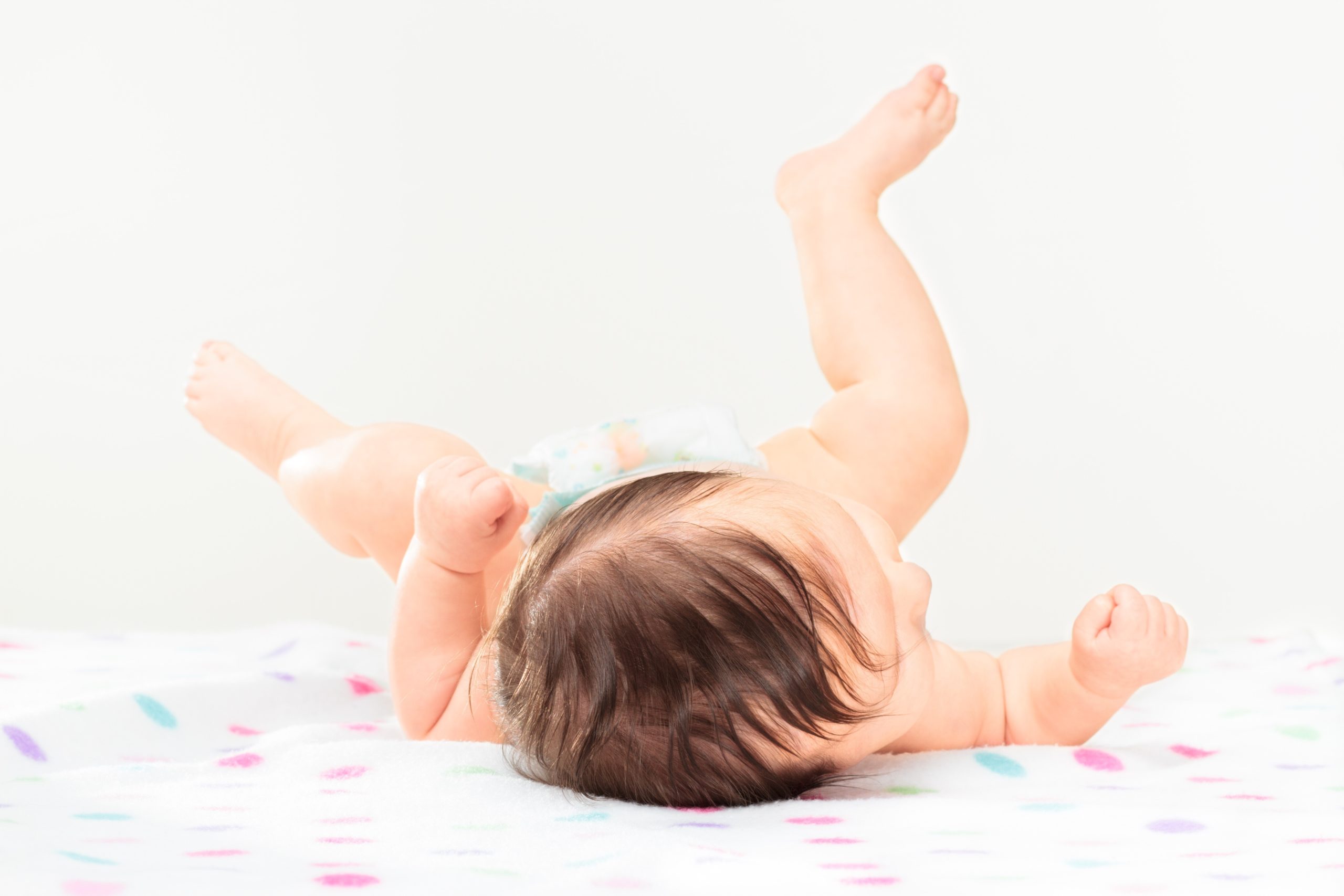baby lying on back kicking legs up in the air - activities for 3-month-old