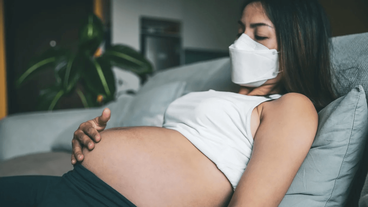 pregnant woman wearing face mask Motherly