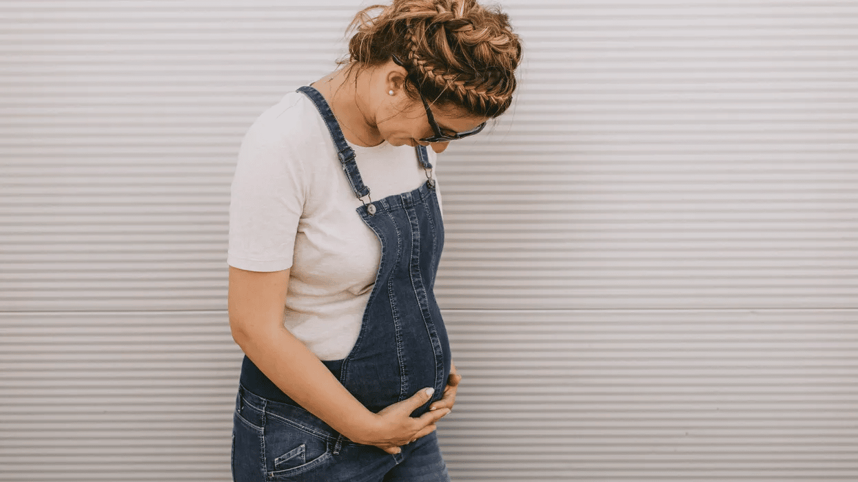 prenatal visit: pregnant woman holding her belly