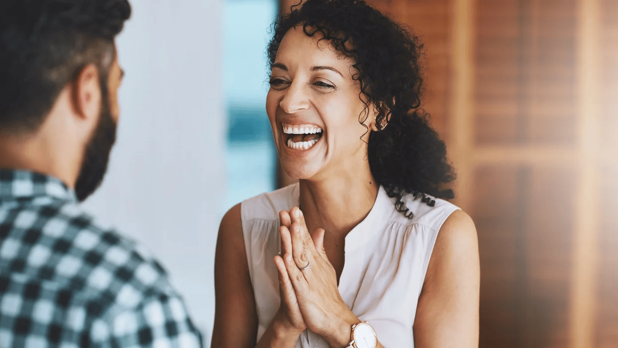 woman clapping and laughing