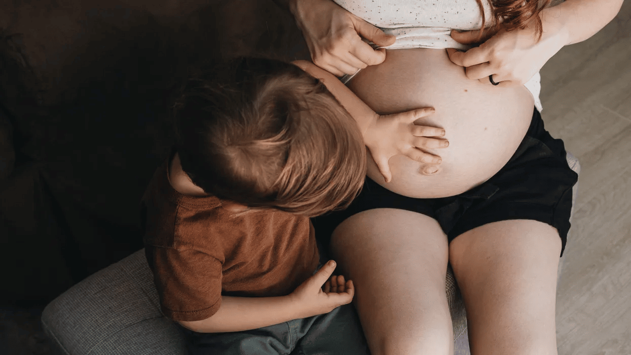 Toddler touching belly