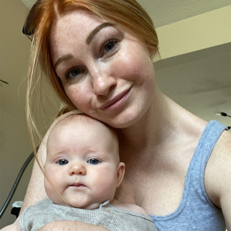 mom holding baby in her lap - essay on postpartum anger