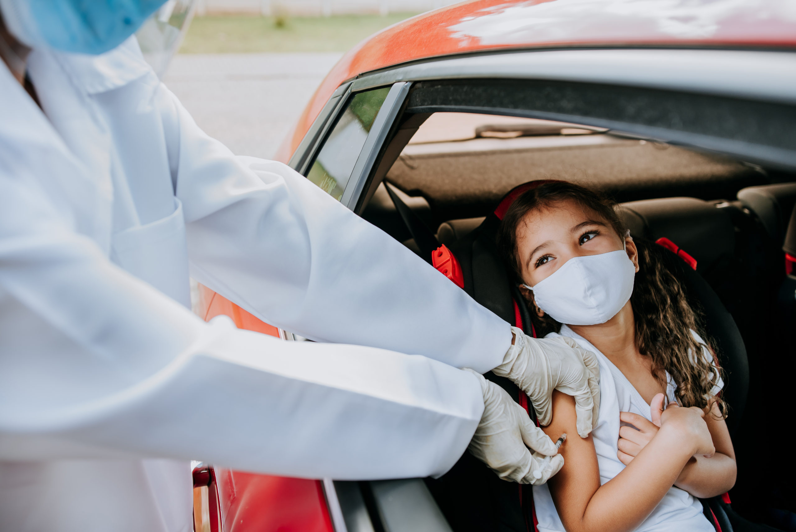 Child being vaccinated in car