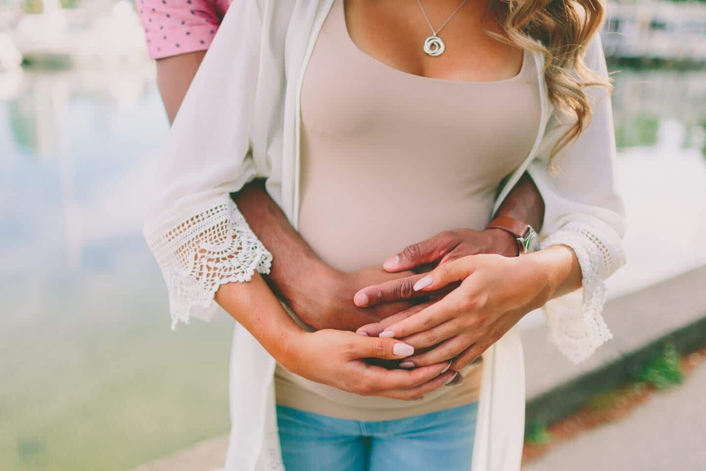 Close up of couple embracing belly