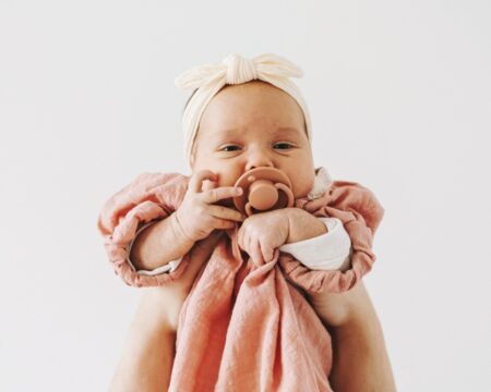 cute baby girl wearing headband pacifier Motherly