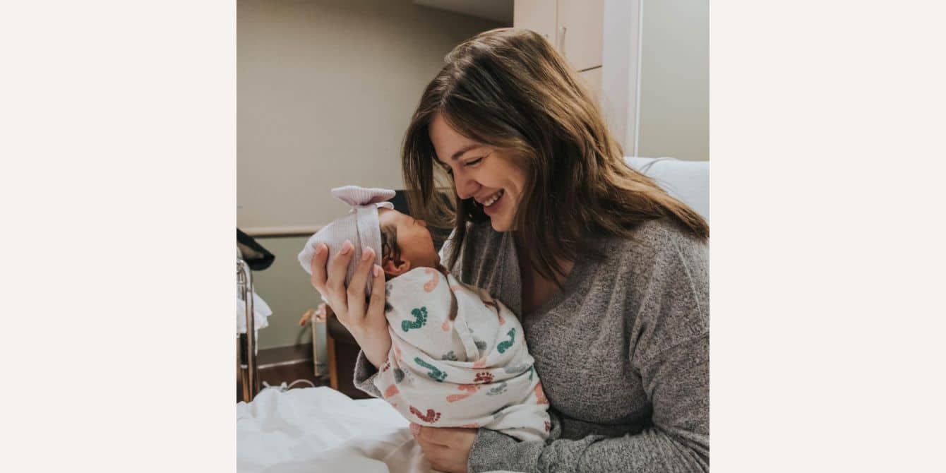 mom looking at newborn baby in hospital - essay on pre-baby life