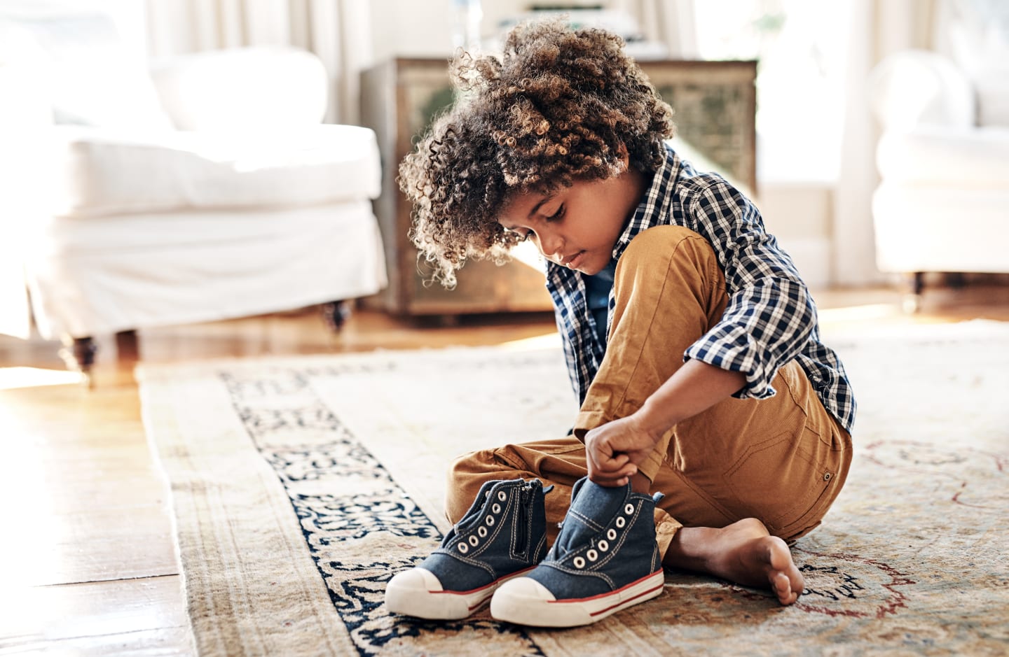 little boy putting on shoes