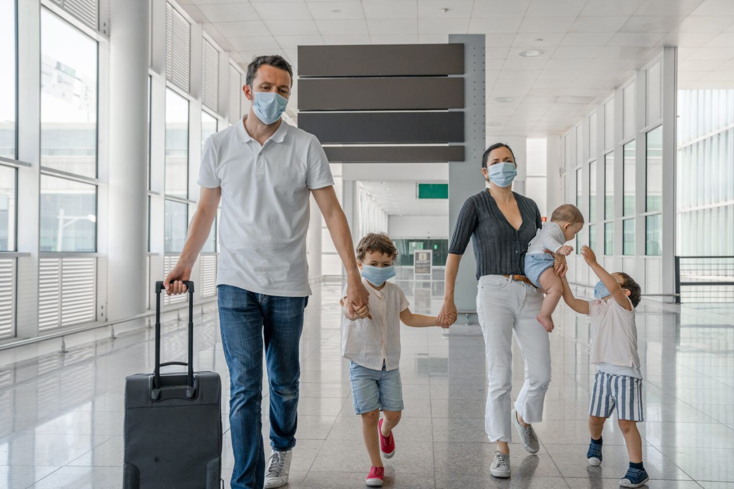 Family travelling with face masks for COVID-19