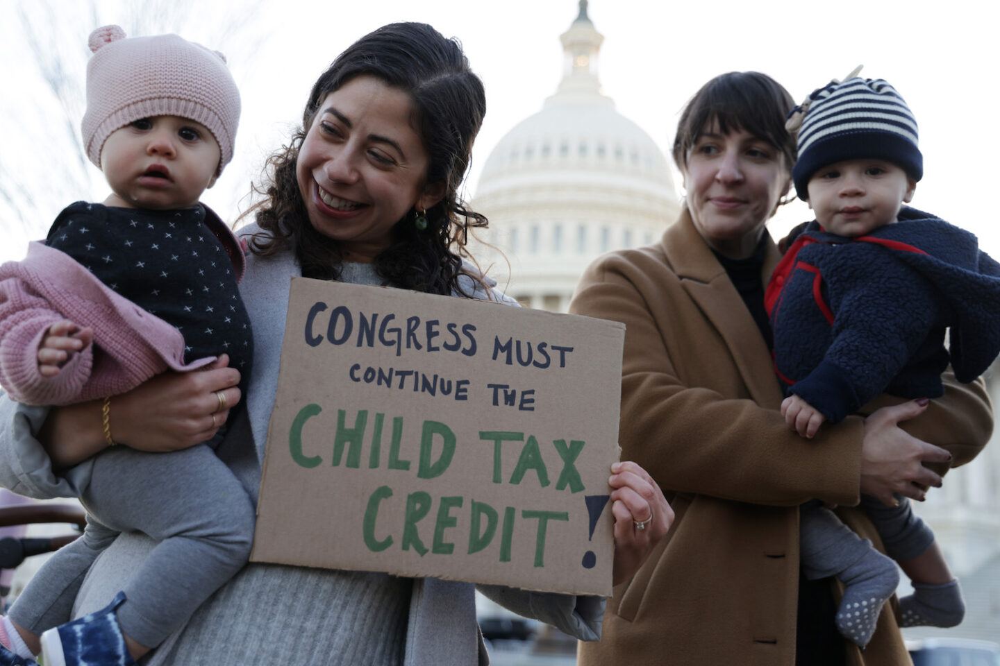 Mothers holding babies outside of Congress