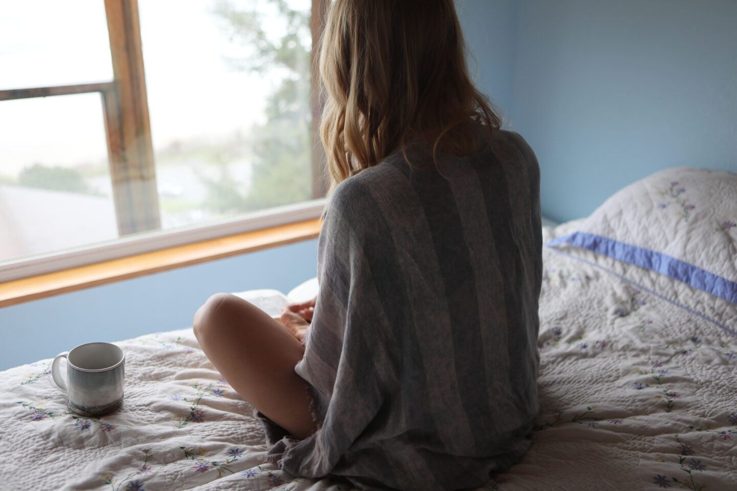 Rear View Of Woman Relaxing On Bed