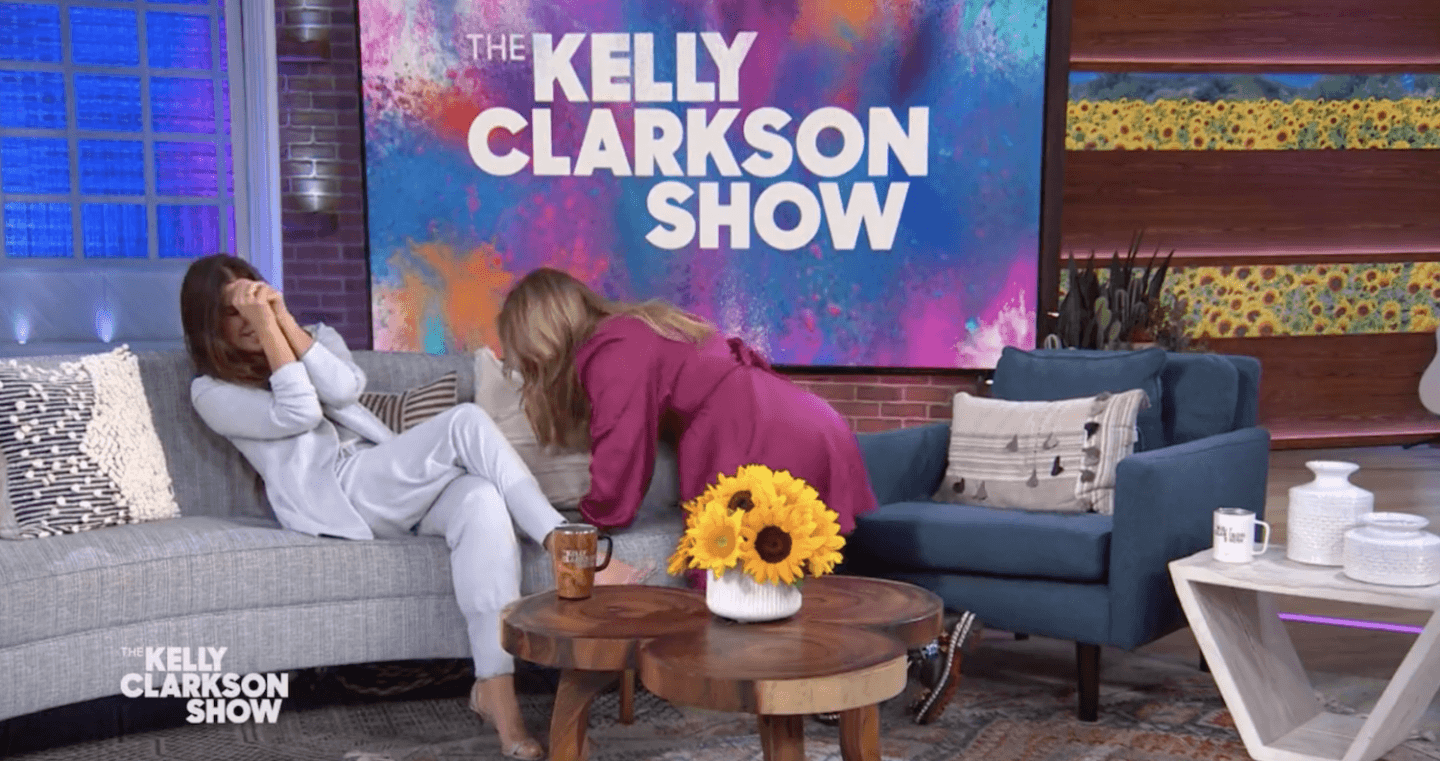 Sandra Bullock and Kelly Clarkson laughing on the set of Kelly's talk show