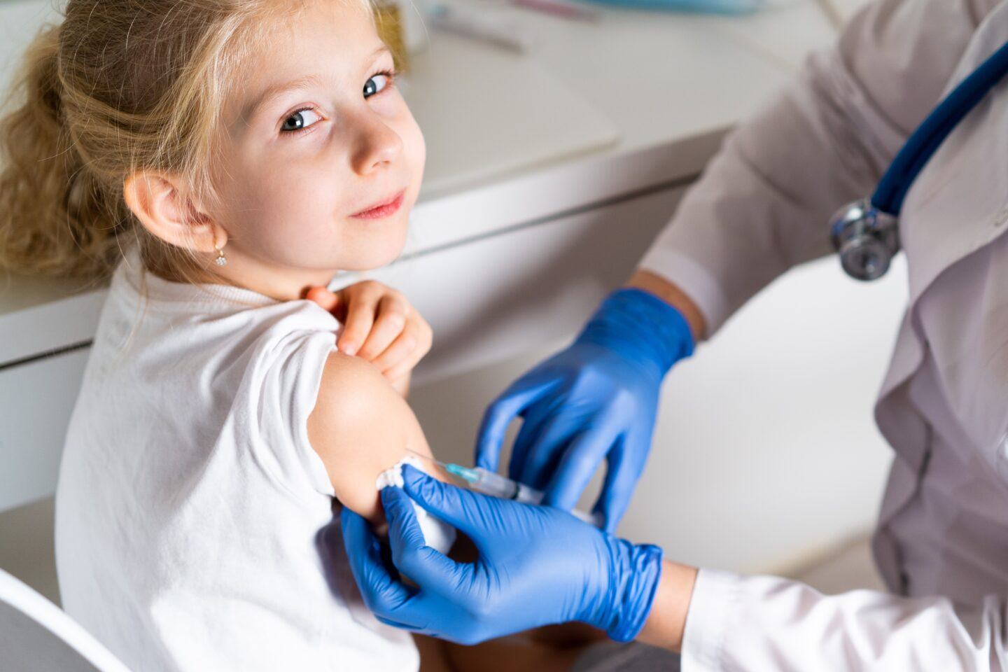 young girl getting vaccinated in doctor's office