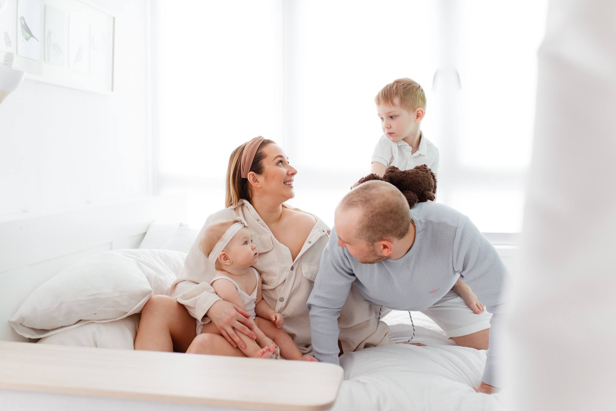 Family resting on a bed and having fun