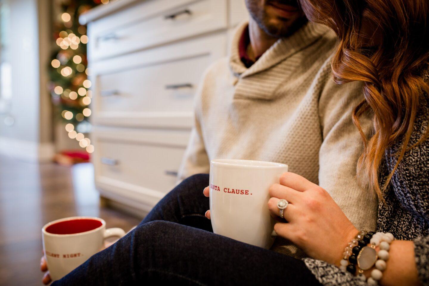 couple snuggling with christmas mugs- no gift christmas