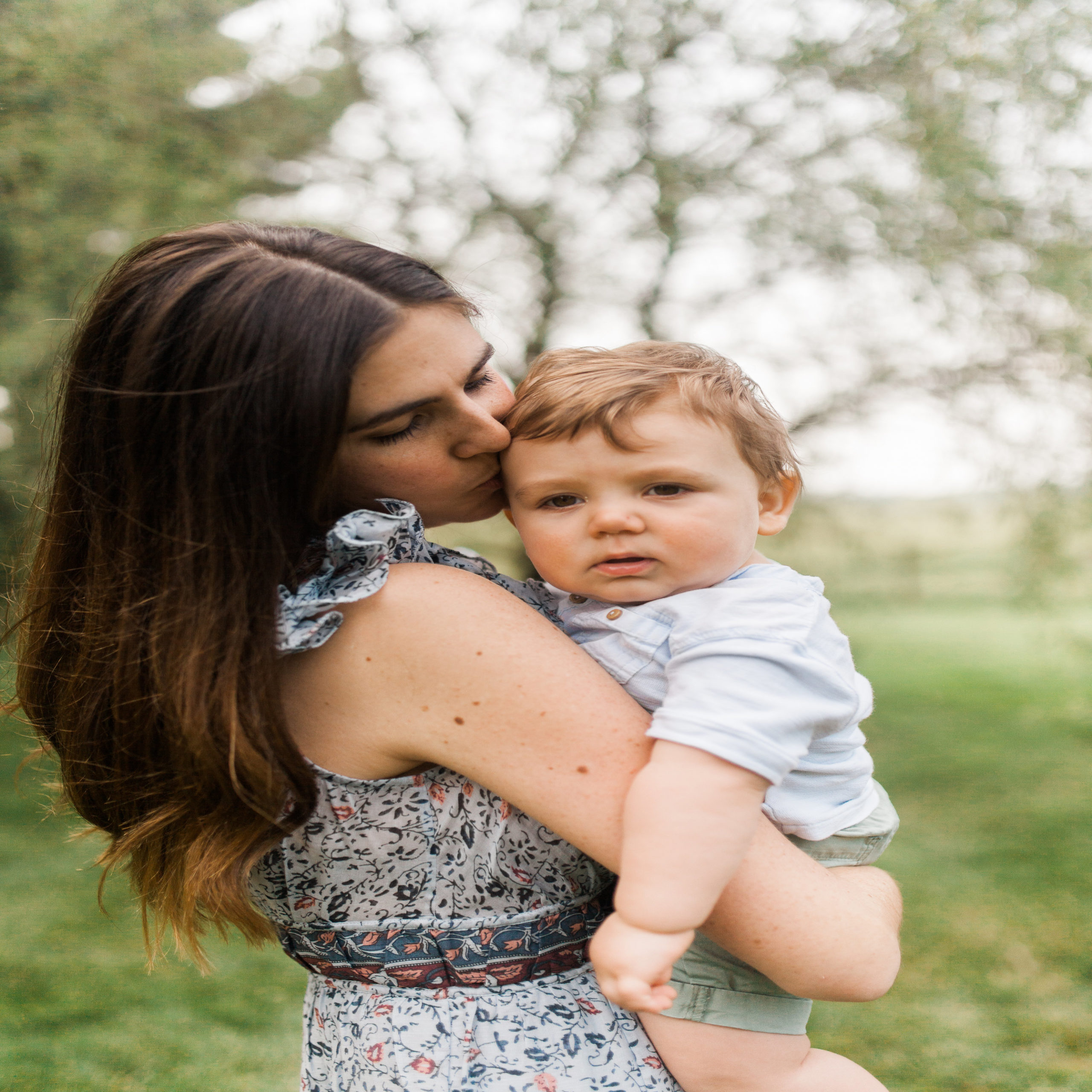 pandemic birth decline: mother kissing baby's head