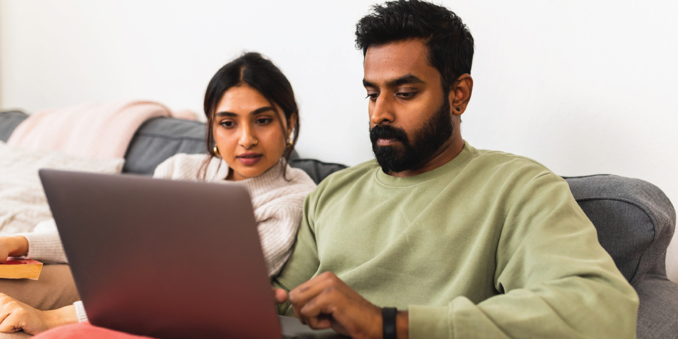 man and woman sitting on the couch with a laptop - how to create a will