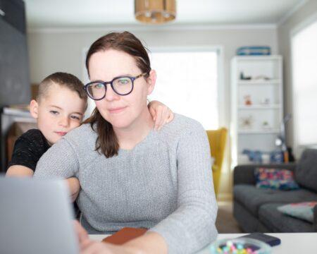 woman working from home with laptop during quarantine home office and parenthood at same time t20 omO9W8