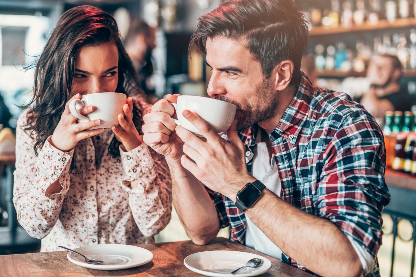 Sex and brain function: Couple drinking coffee at cafe and looking at each other