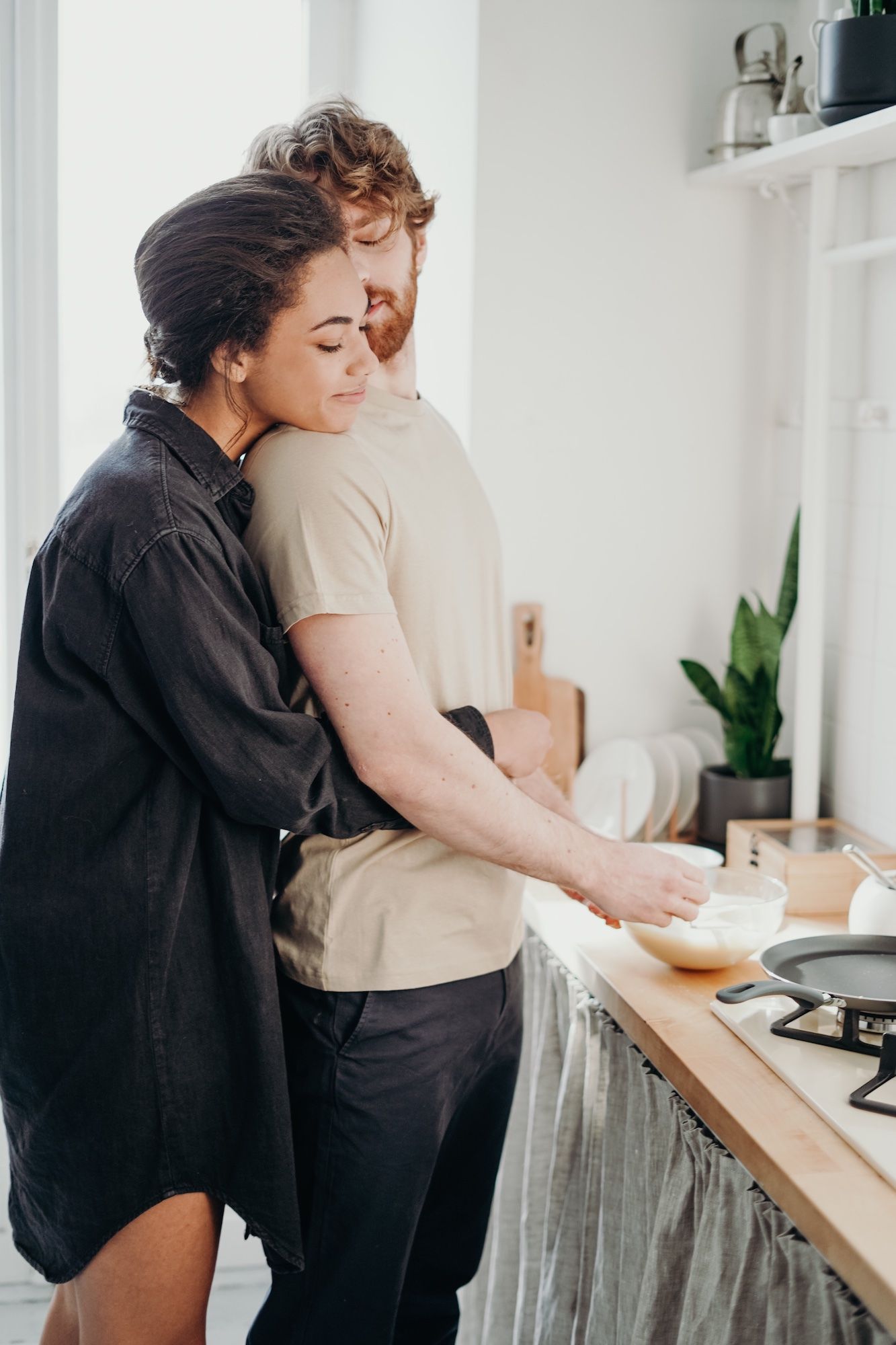 couple hugging in kitchen rekindling their love