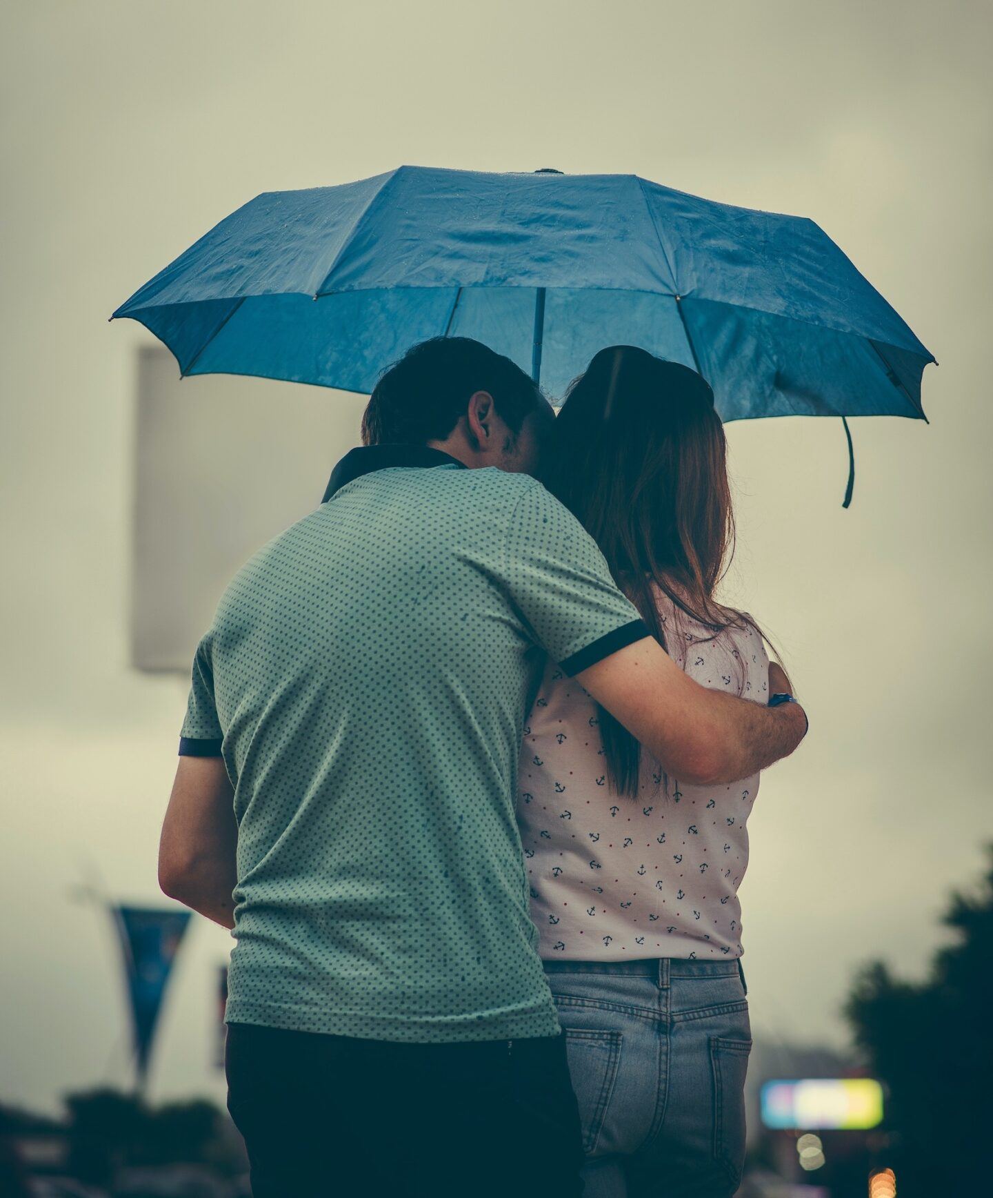 couple hugging under an umbrella