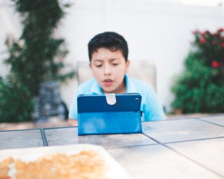 young boy playing with ipad t20 K6RArV Motherly