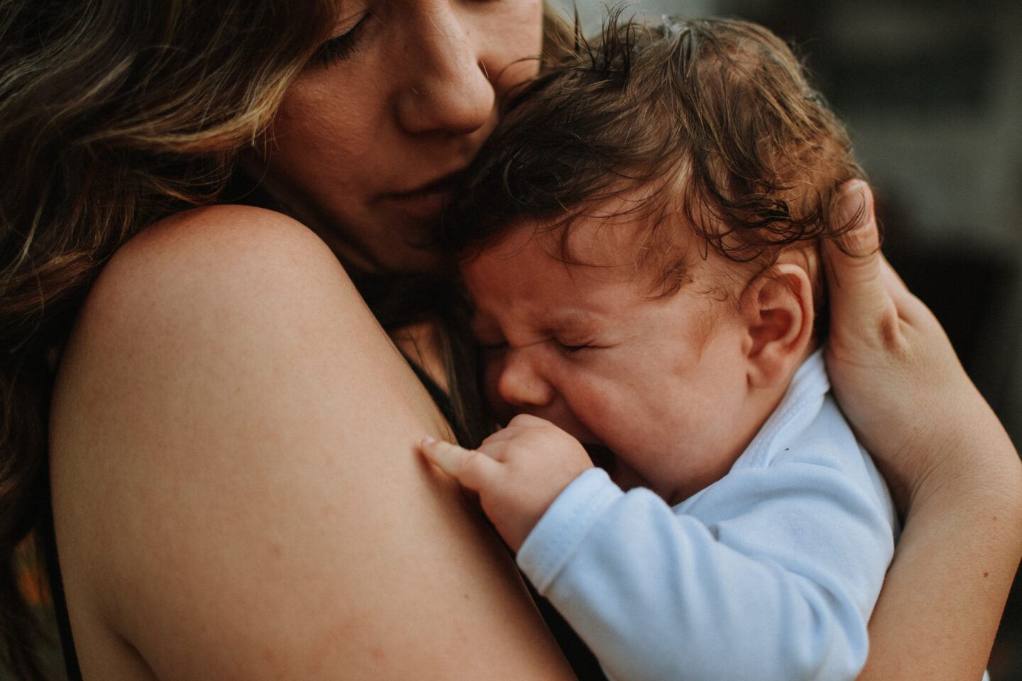 postpartum: mother holding crying baby