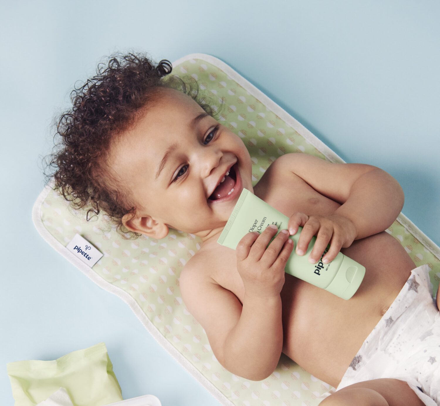 smiling baby with lotion