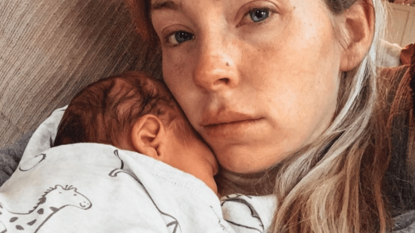 Postpartum anxiety: sad mom holding newborn