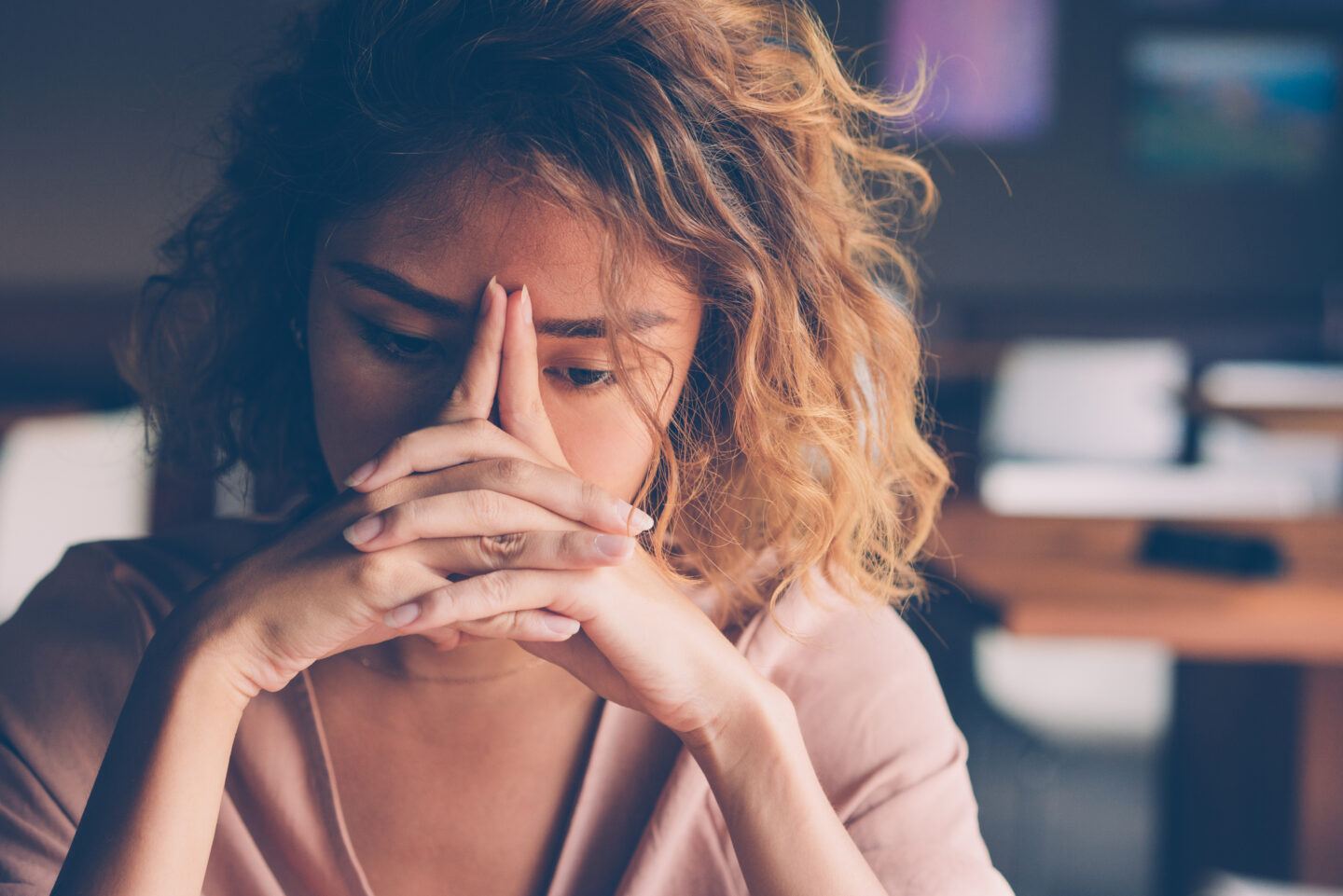 Burnout: young woman with head in hands