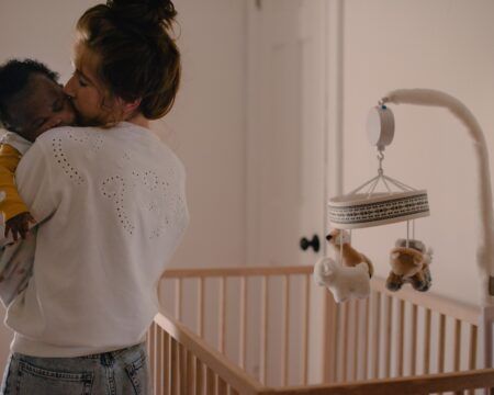 minimalist nursery with mom holding and hugging baby t20 2WonmO