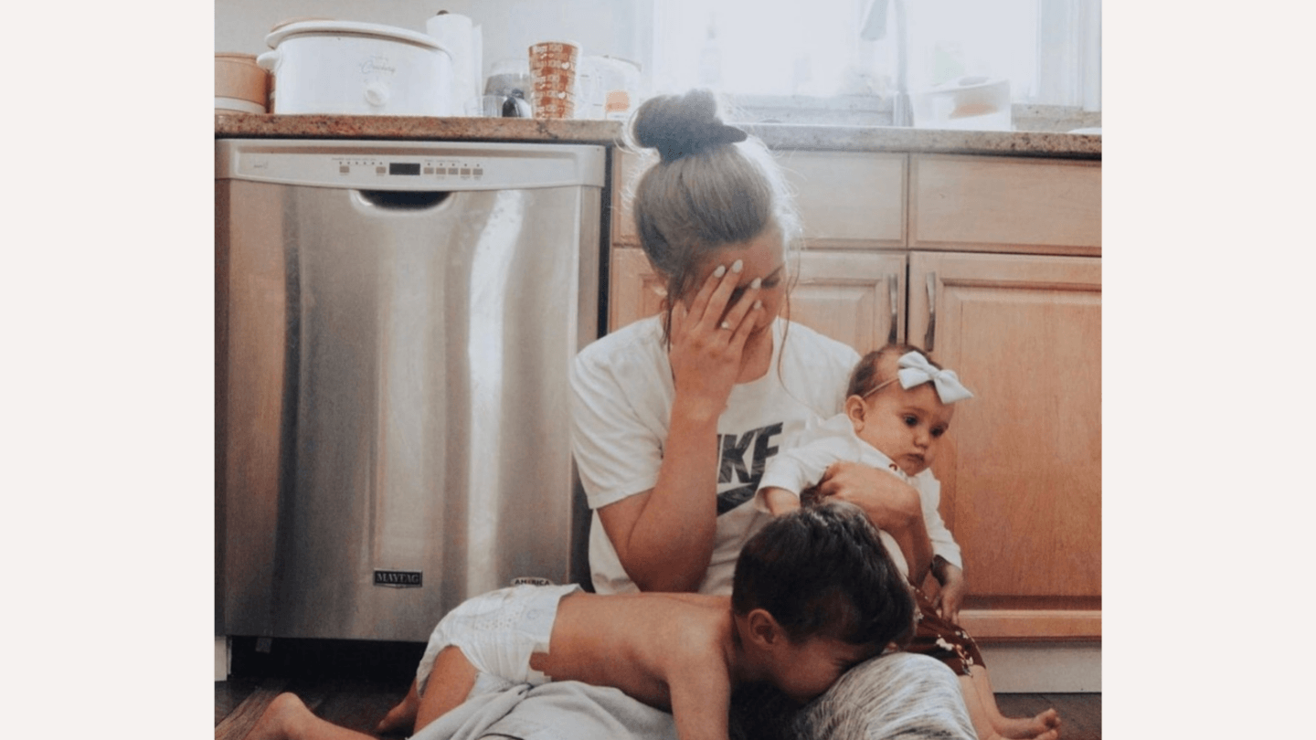 Mom who feels overwhelmed: mom sitting on the floor with baby and toddler