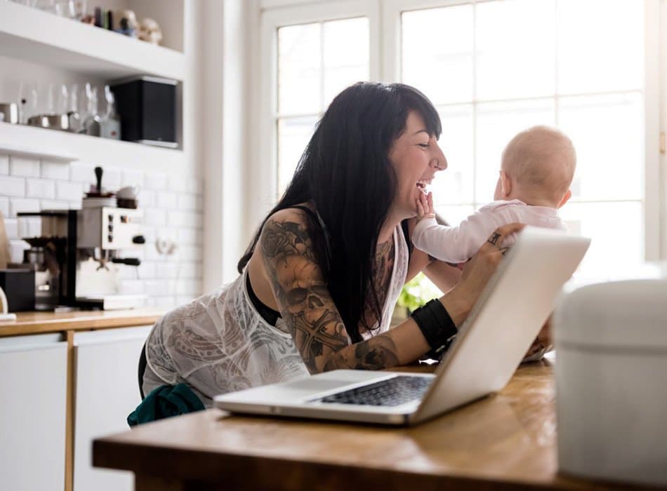 Mom with baby using laptop