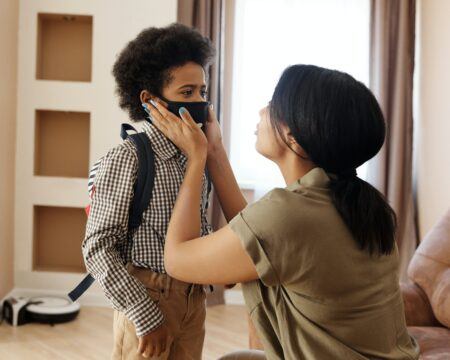 BA.2 variant: mother helping son wear a face mask